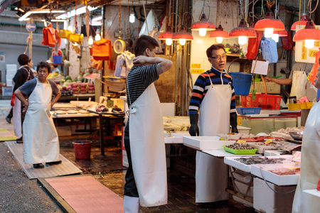 Hong Kong, Special Administrative Region of the People's Republic of China - 19 April 2016: Asian man selling seafood on traditional wet marketのeditorial素材