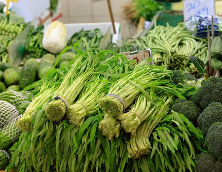Traditional asian market with fresh exotic vegetables and herbs