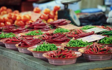 Traditional asian market with fresh green and red chili pepper