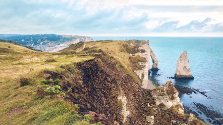 Etretat steep arch shaped cliff at low tide, view from above, Normandy, Franceの写真素材