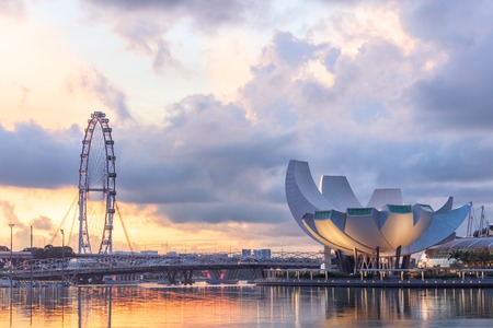 Singapore, Republic of Singapore - May 4, 2016: Panorama of Marina Bay with Artscience lotus flower museum, Flyer observation wheel and Helix bridge at sunsetのeditorial素材