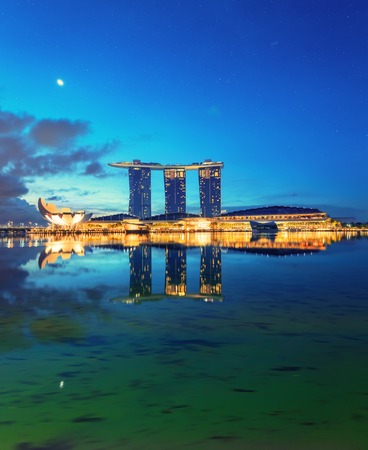 Singapore, Republic of Singapore - May 4, 2016: Marina Bay Sands hotel glowing at night reflecting in waterのeditorial素材