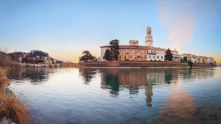 historical quarter of Verona, panorama from river on ponte Pietra bridge and Duomo Cathedral at sunriseの写真素材