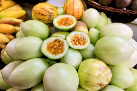 Traditional market stall full of fresh yellow maracujas