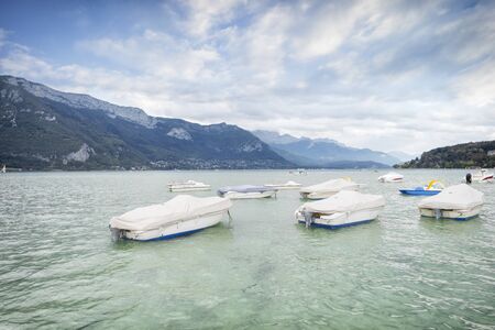 Lake of Annecy. Moody landscape with boatsの写真素材
