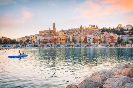 Public beach of Menton old town at sunsetの写真素材