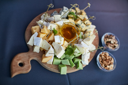 cheese platter, Assorted with nuts and honey on a plateの写真素材