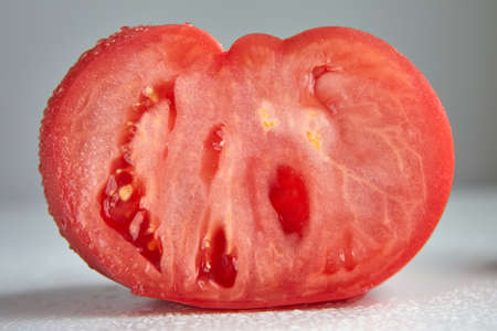 fresh textured tomato in a cut on an insulating backgroundの写真素材