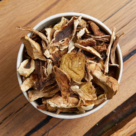 Dried mushrooms in a plate on a wooden tableの写真素材
