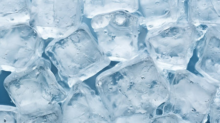 A close up of ice cubes in a blue background. The ice cubes are arranged in a way that they look like they are melting. The image has a cold and icy feel to itの素材