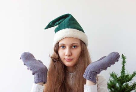The girl in the elf's hat spread her arms to the sides.の写真素材