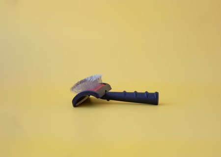 Groomers Tool Dog comb on yellow background Side viewの写真素材