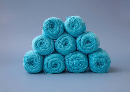 Blue balls of cotton yarn lie in a pyramid on a blue background knitting aestheticsの写真素材