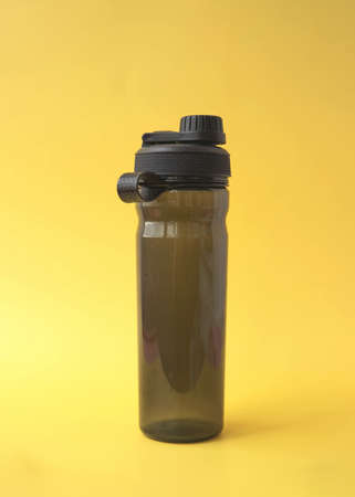 Sports water bottle made of black transparent plastic fitness concept.