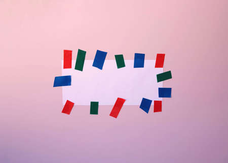 A template for recording a frame with a white piece of paper glued to the pink wall with...