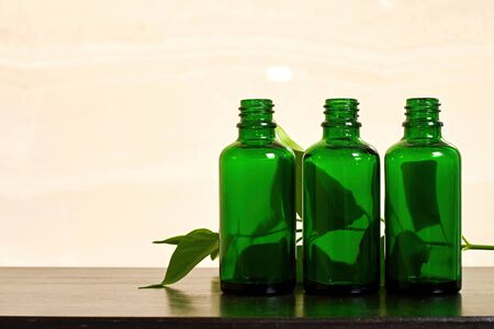 Transparent bottles with body care cream in the bathroom. Traditional cosmetic and personal care products. Herbal medicine. Copy space for advertisement textの写真素材