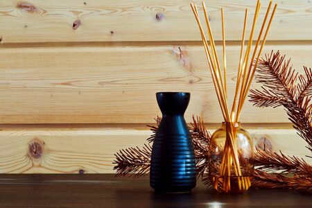 Bottle with aroma oil on the wooden table in the spa center. Cosmetics and healthcare background with copy spaceの写真素材