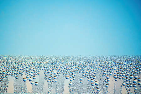 Beverage glass misted with bubbles and foam. Background texture with copy space for advertisement...