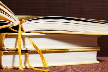 Opened a novel book on the pile of books in the library. Literature and study symbols
