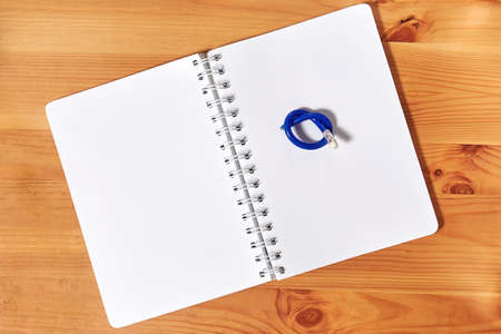 A notepad with knotted broken pencil on it. Back to school concept