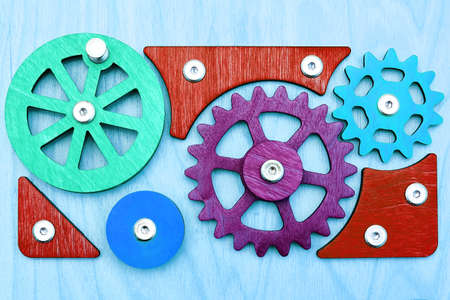Colorful wooden gears on the busy board. Kids toys and backgroundsの写真素材