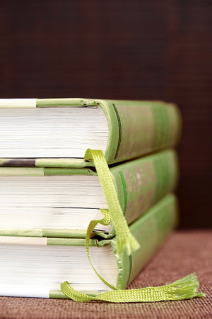 Stack of green books on the bookshelf in the library. Education backgroundsの写真素材