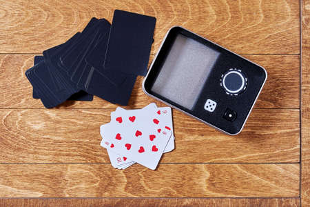 Poker case with playing cards, dice and chips on the wooden surface. Leisure activity and gambling...