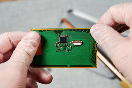 An engineer working on repairing a microchip in a tech laboratory. Manufacturing and nanotechnology conceptの写真素材