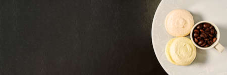 Header template with coffee beans in an espresso cup and tasty macaroon. Food and drink backgrounds. Cafe tableの写真素材