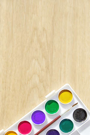 Vertical web-banner template with watercolor paints and brushes in a palette. Hobby and leisure...