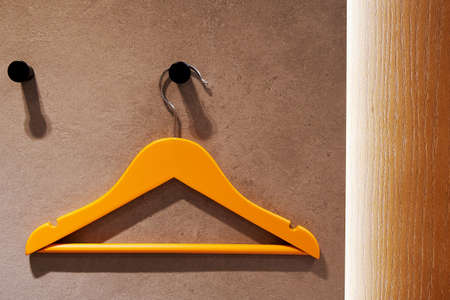 Bright orange hander in the modern home interior. Clothes storage for family and kidsの写真素材