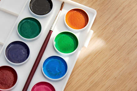 Palette with vivid paints and brush - close-up view. Arts and hobby backgroundsの写真素材
