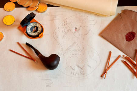 Table with an old treasure map, smoking accessories, compass, and coins. Games and adventures and...