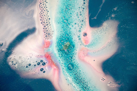 Bright water bomb splash in the bat with blue and pink bubbles and foam. Decorative bath foam