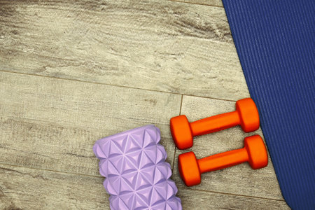 Fitness equipment on the wooden floor in the gym. Sports and activity backgrounds and templates. Toned imageの写真素材