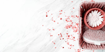 Basket with the shower and spa equip, chamomile, scrub brush on the marble surface. Pink sea salt. Banner with copy space for templateの写真素材