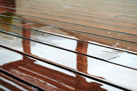 Wet terrace wooden floor with reflected furniture. Buildings abstract backgroundsの写真素材