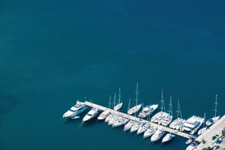Aerial view of marina with ships and pier and azure sea water. Abstract background texture