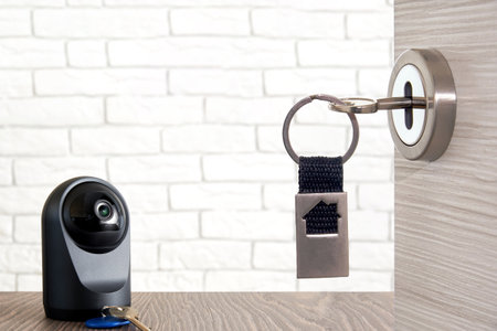 Opened door with key and IP camera on the table. Control your house access