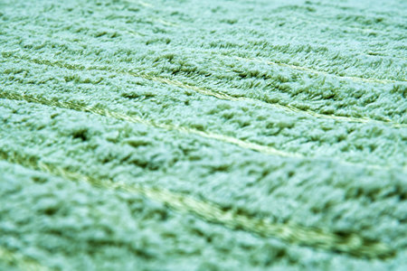 Detailed view of green furry texture with visible threads. The image is great for illustrating a cozy feelingの写真素材