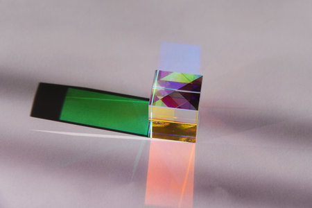 A geometric prism refracts light, creating a vibrant spectrum of colors and shadows. Abstract...