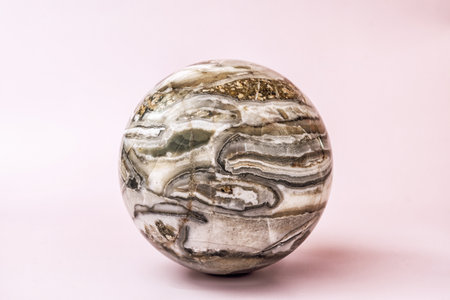 Detailed view of polished agate sphere showcasing its intricate patterns and captivating colors....