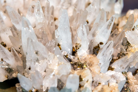 Glistening clear quartz crystal cluster with golden pyrite inclusions. Natural beauty, perfect for...
