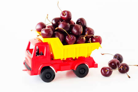 toy car with a sweet cherry in the backの写真素材