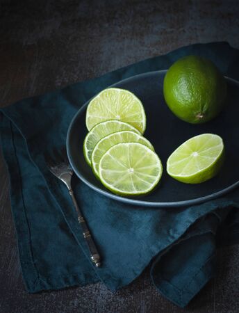 Lime sliced for tea party. Dark photoの写真素材