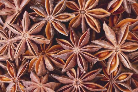 Christmas mood food background: scattered anise stars with seeds. Warming Christmas spices.の写真素材