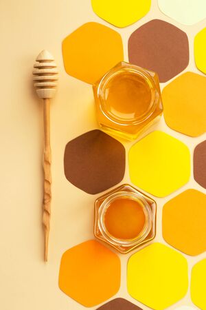 Collage: two jars of honey, a wooden spoon for honey and a stack of paper.の写真素材