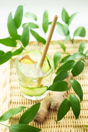 a glass of ginger water with a bamboo cocktail tubeの写真素材