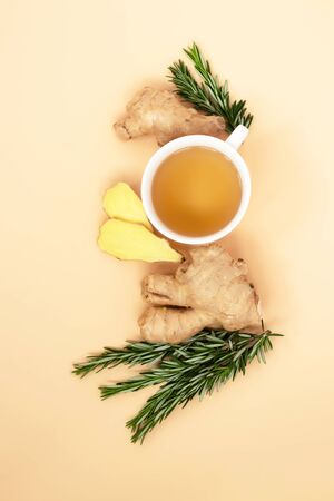 
 Tea, ginger and rosemary on a light background. Calm, natural colors for relaxation reduce stress, set up for self-care and recovery. Adaptogens improve health and boost the immune system
の写真素材