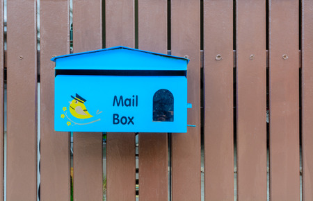 blue mailbox with brown  backgroundの写真素材